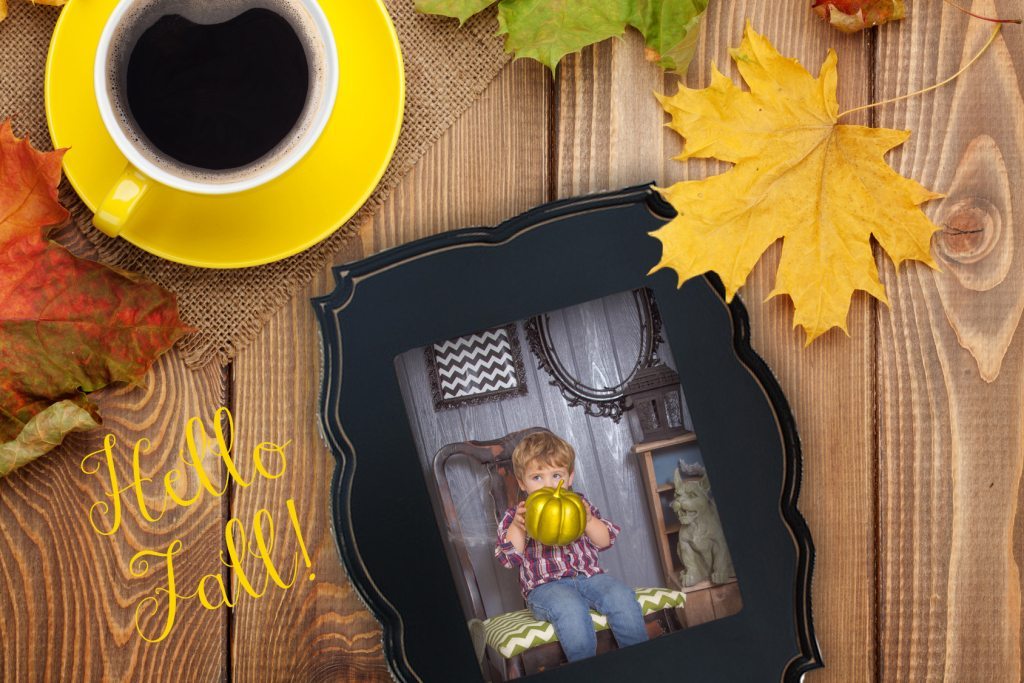 Autumn leaves and coffee cup over wood background