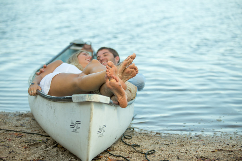 Melbourne beach photographer's engagement shoot of a couple in a canoe by the inter coastal 