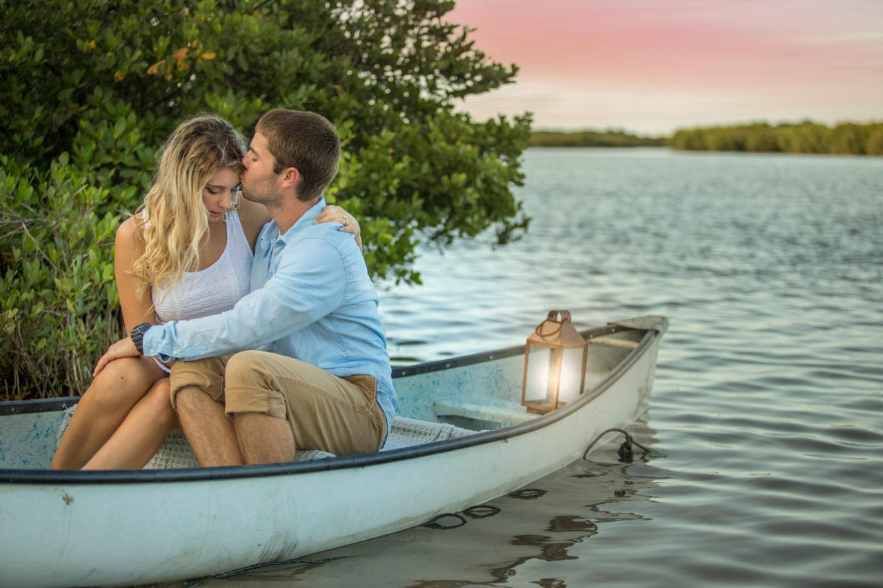 Engagement photos taken in a canoe in the river at New Smyrna Beach, FL