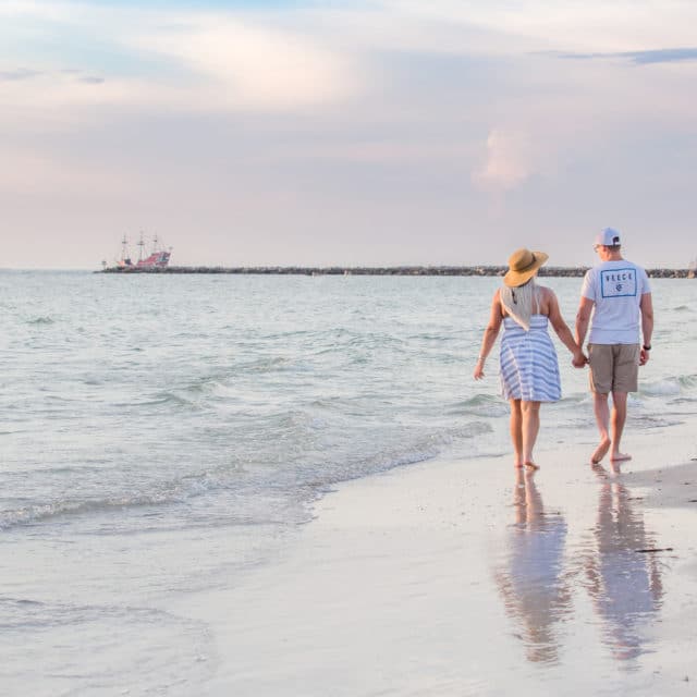 Clearwater photography of couple walking along the beach at sunset