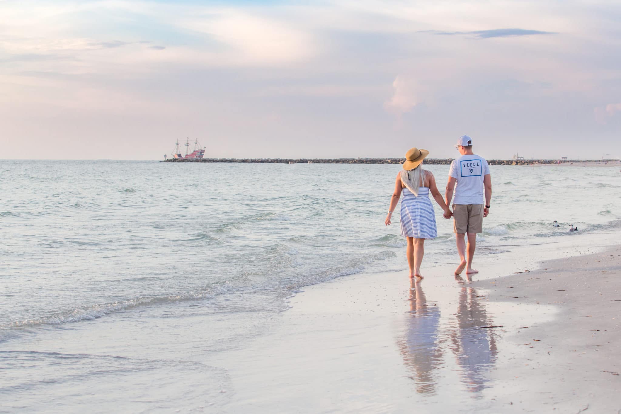 Clearwater photography of couple walking along the beach at sunset