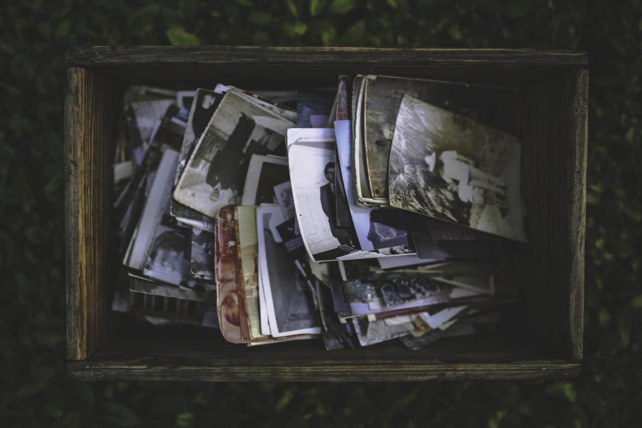 Orlando family photographers post about photo storage with an image of old photographs in a box