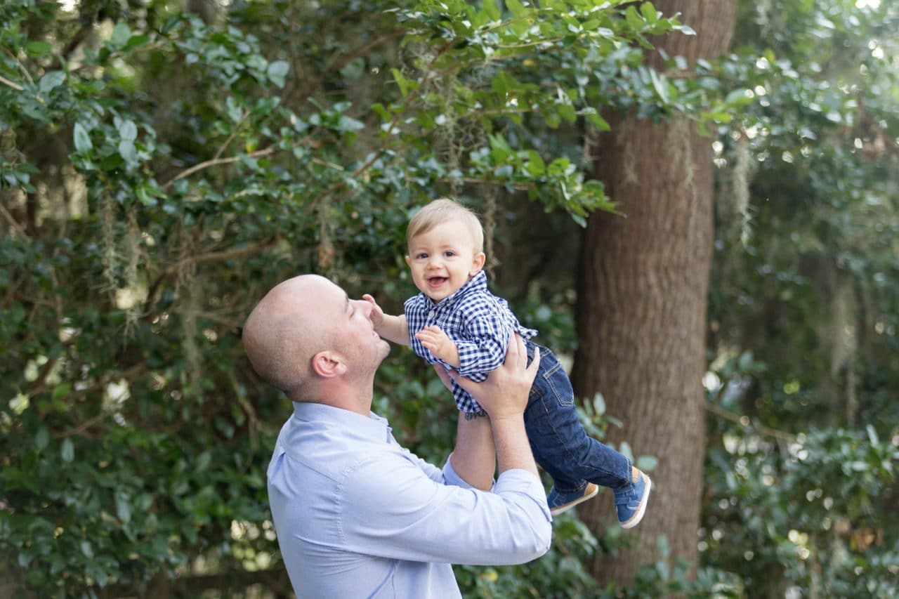 Family portrait photographer captures photograph of dad and son smiling