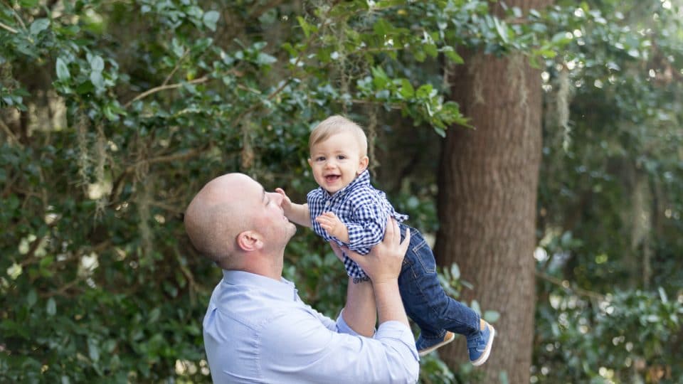 Family portrait photographer captures photograph of dad and son smiling