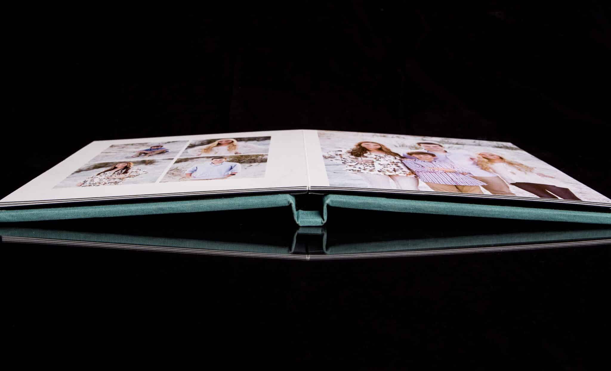 New Smyrna Beach photographer captures image of a photo album laying flat and open showcasing a beach portrait session in New Smyrna Beach with a black background
