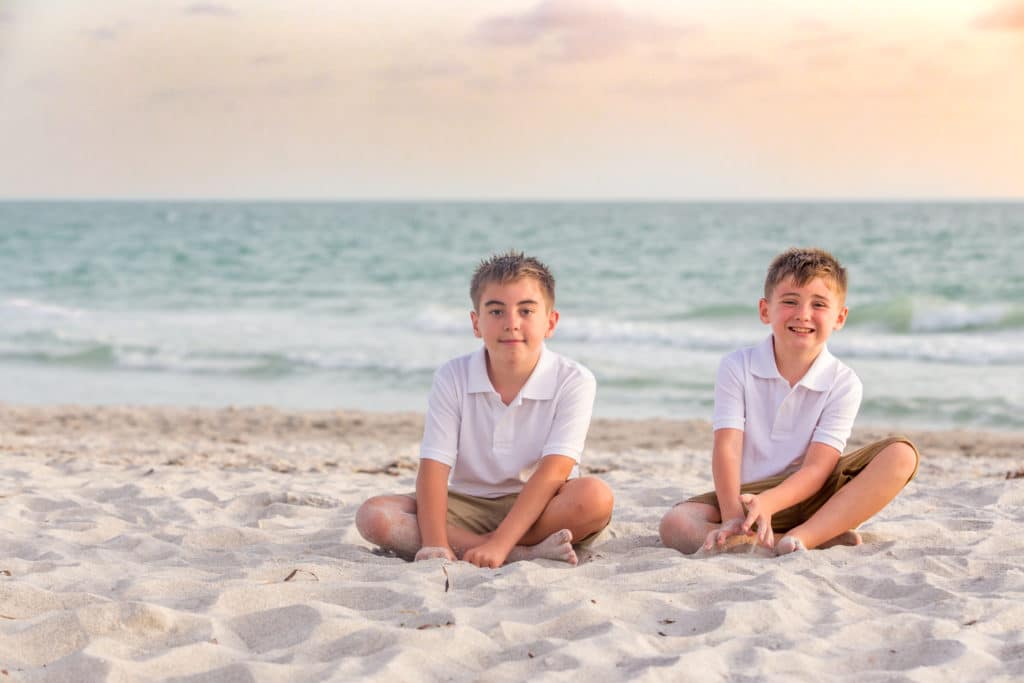 Longboat key family beach photography at sunset with ocean in the background and white sand