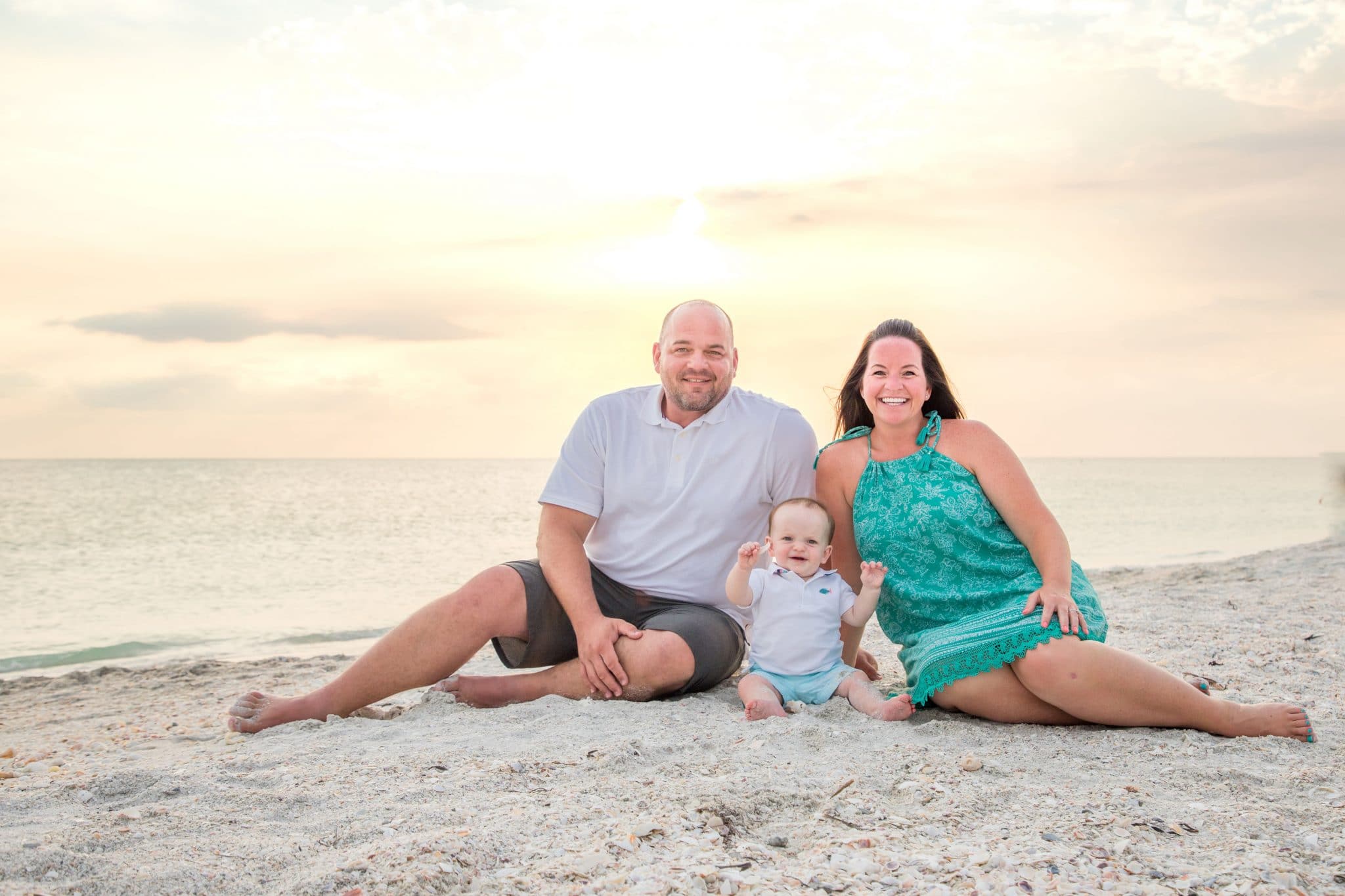 family photo at sunset on the beachin lido key fl