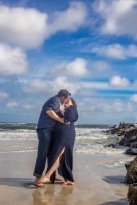 couple kissing at the beach in new smyrna beach florida for a photoshoot