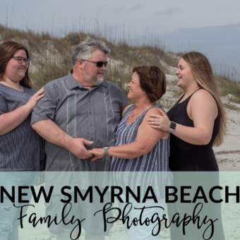 New Smyrna Beach family photography with sand dunes in the background, red lighthouse and a little bit of the ocean showing. Family of four with two adult daughters.