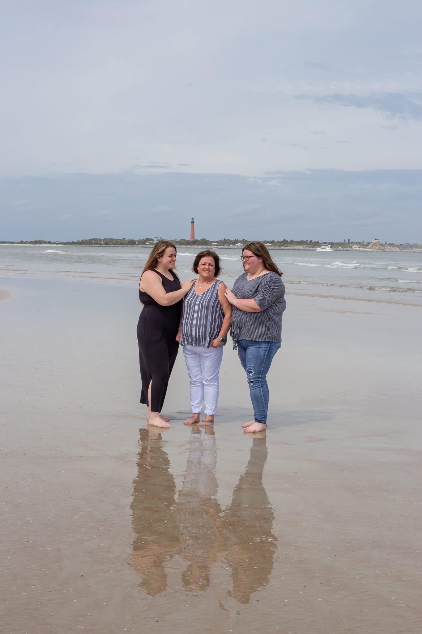 New Smyrna Beach photography in front of the lighthouse at Smyrna Dunes Park with mom and her two adult daughters