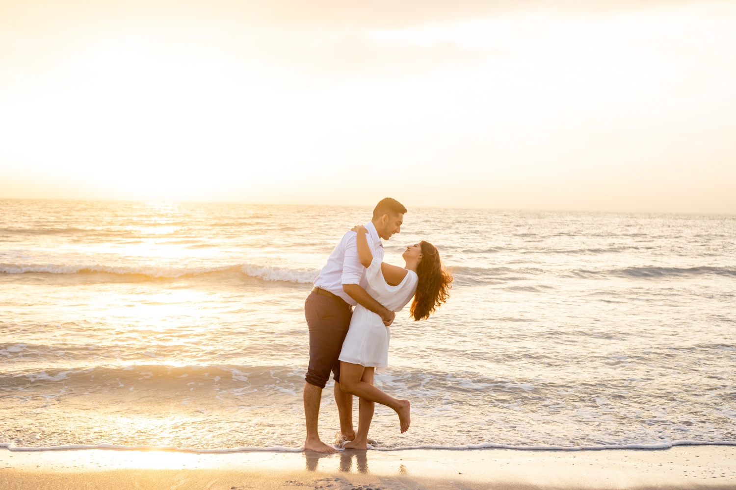 engagement photographers clearwater capture portrait of couple at sand key park at sunset