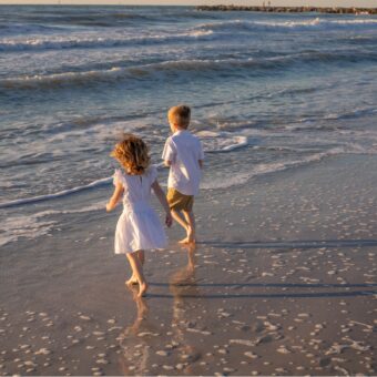 two kids playing on the breach during a Clearwater Beach family photography session