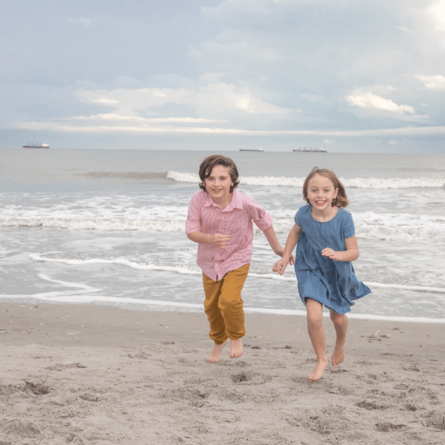 kids running on the beach for a family photographer in cocoa beach fl