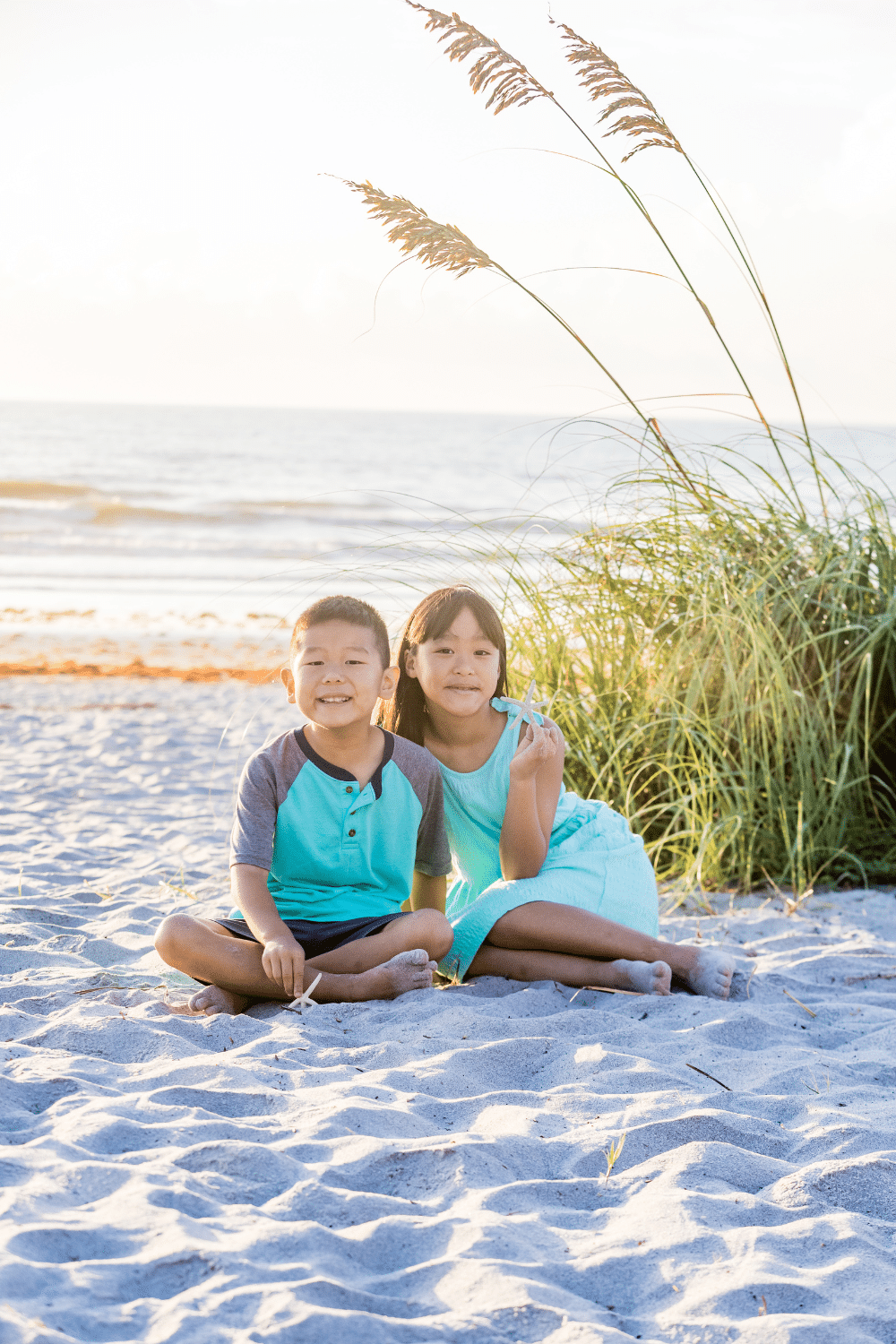 brother and sister wearing teal for a beach photoshoot with a cocoa beach photographer