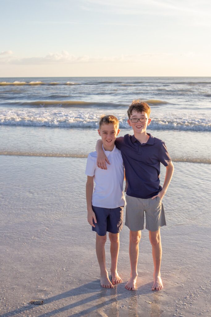 brothers pose together on the beach for a siesta key photographer