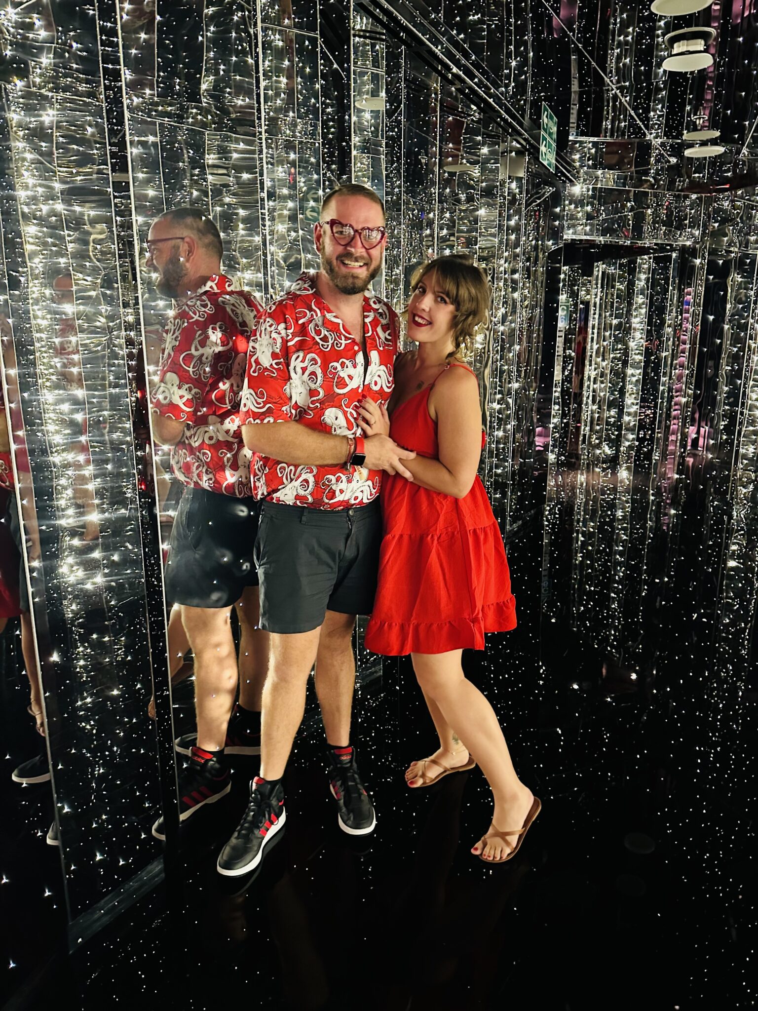 Jon & Heather Hinson of Hinson Photography wearing red while on a cruise vacation
