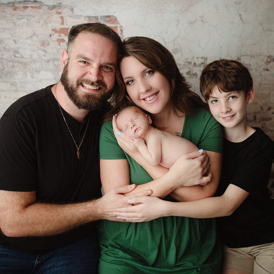 family portrait of a family of 4 with two boys and mom and dad for their photography about me